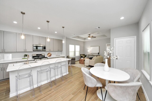 326 Gans St Unit A, Houston, TX 77029 - dining room featuring baseboards, light wood finished floors, recessed lighting, and a raised ceiling