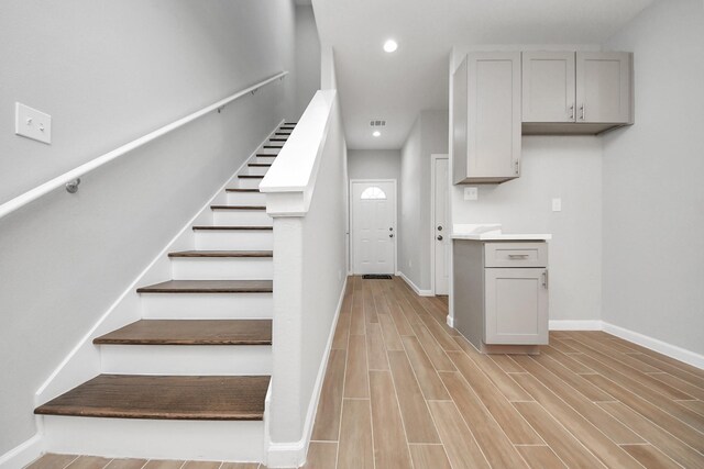 326 Gans St Unit A, Houston, TX 77029 - stairway featuring recessed lighting, baseboards, visible vents, and wood finished floors