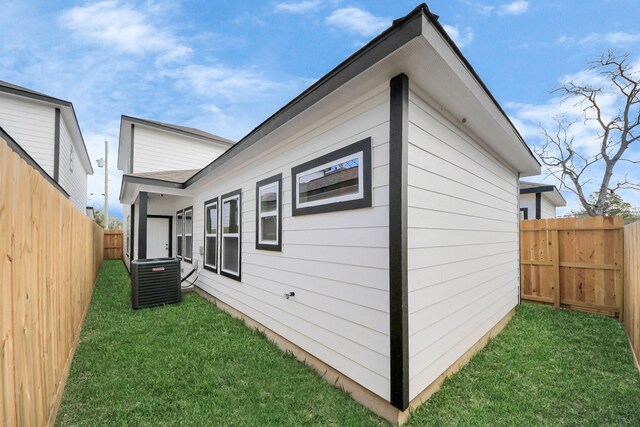 326 Gans St Unit A, Houston, TX 77029 - view of property exterior featuring central air condition unit, a yard, and a fenced backyard