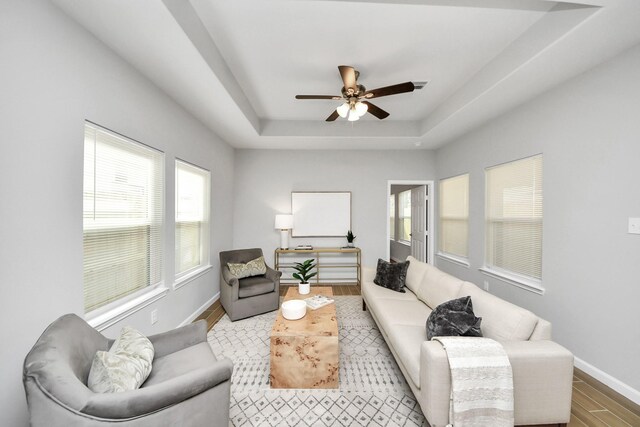 326 Gans St Unit A, Houston, TX 77029 - living room featuring a raised ceiling, ceiling fan, wood finished floors, and a healthy amount of sunlight