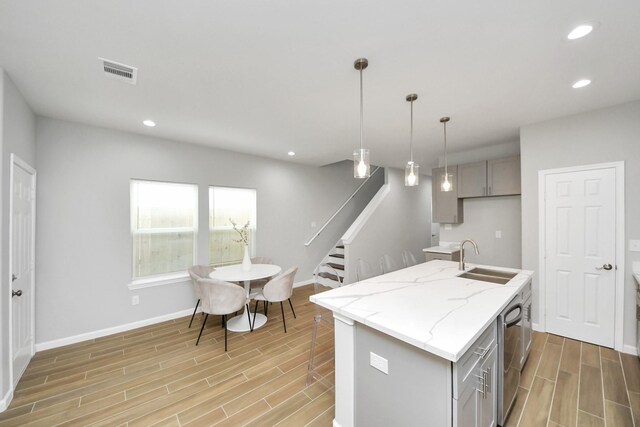 326 Gans St Unit A, Houston, TX 77029 - kitchen with gray cabinets, visible vents, a sink, and wood tiled floor