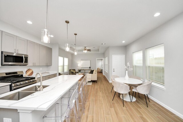 326 Gans St Unit A, Houston, TX 77029 - kitchen with recessed lighting, baseboards, appliances with stainless steel finishes, and gray cabinetry