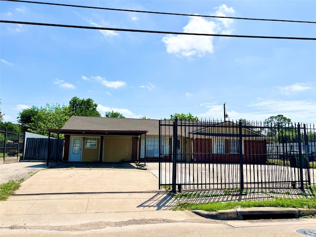 view of front of home with a fenced front yard and driveway