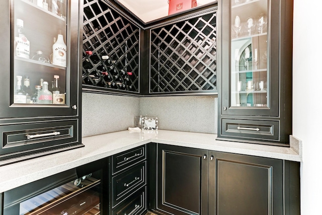 bar featuring wine cooler and a bar