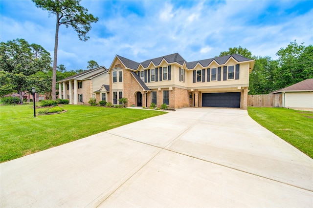 view of front of property featuring a garage, fence, a front yard, brick siding, and driveway