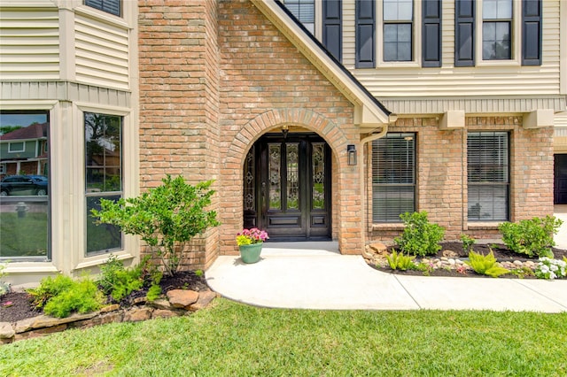 entrance to property with brick siding and french doors