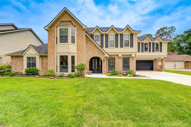 view of front of property featuring brick siding, an attached garage, driveway, and a front lawn
