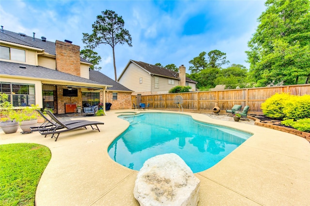 view of pool with a fenced backyard, a ceiling fan, and a patio area