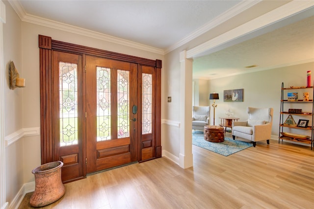 foyer featuring light wood-type flooring, baseboards, and crown molding