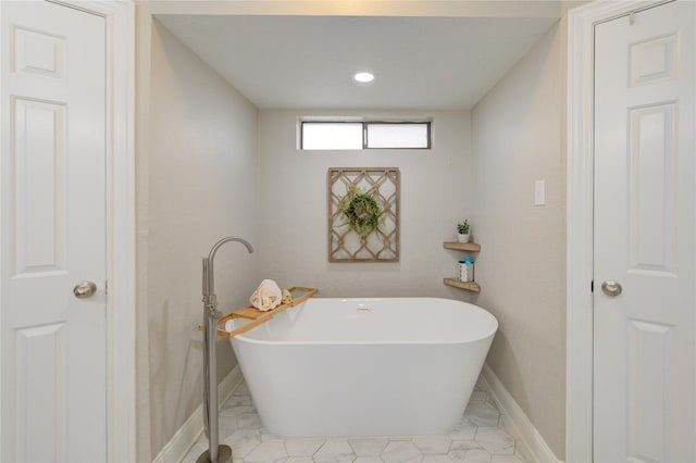 full bath featuring baseboards, recessed lighting, marble finish floor, and a freestanding bath