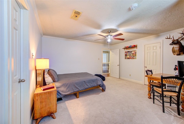 bedroom with baseboards, ornamental molding, light carpet, and visible vents