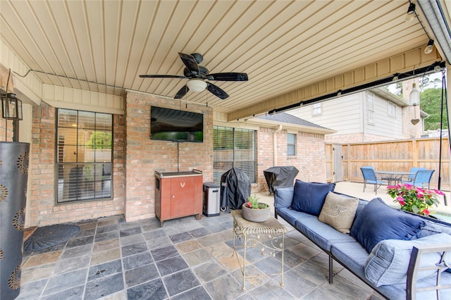 view of patio / terrace with a ceiling fan, fence, and an outdoor hangout area