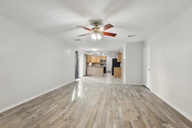 unfurnished living room with baseboards, a ceiling fan, light wood-type flooring, and visible vents