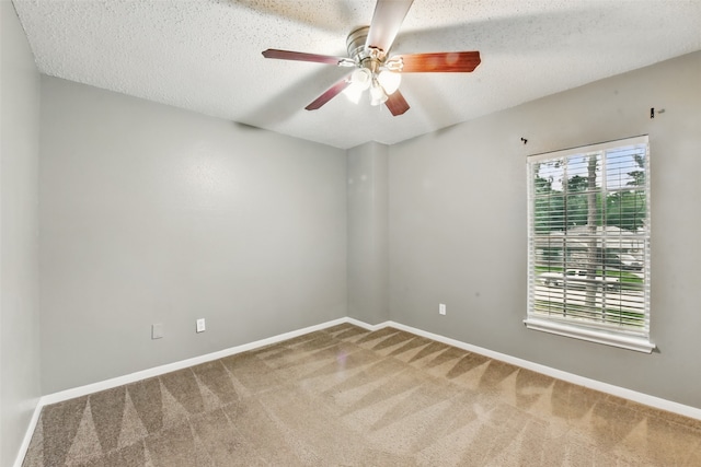 spare room featuring carpet flooring, a ceiling fan, and baseboards