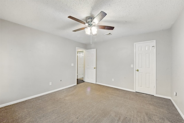 unfurnished bedroom featuring visible vents, baseboards, a textured ceiling, a ceiling fan, and carpet