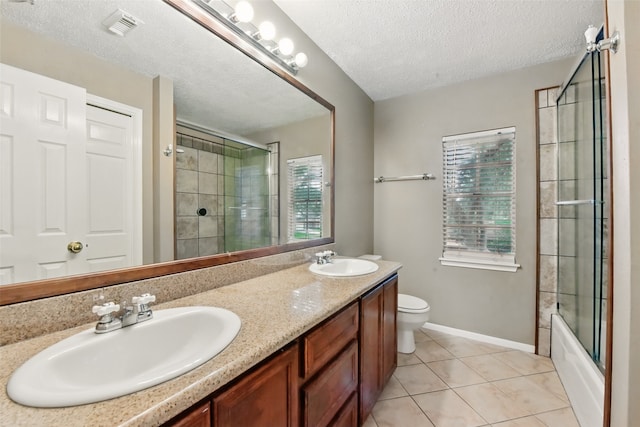 bathroom featuring toilet, tile patterned floors, visible vents, and a sink