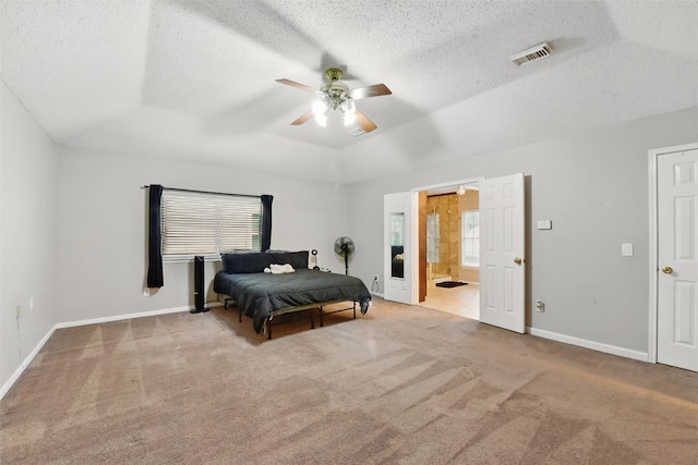 carpeted bedroom with multiple windows, a textured ceiling, and visible vents