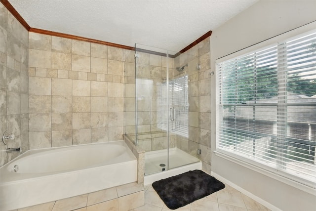 bathroom with a garden tub, tile patterned flooring, a stall shower, and a textured ceiling