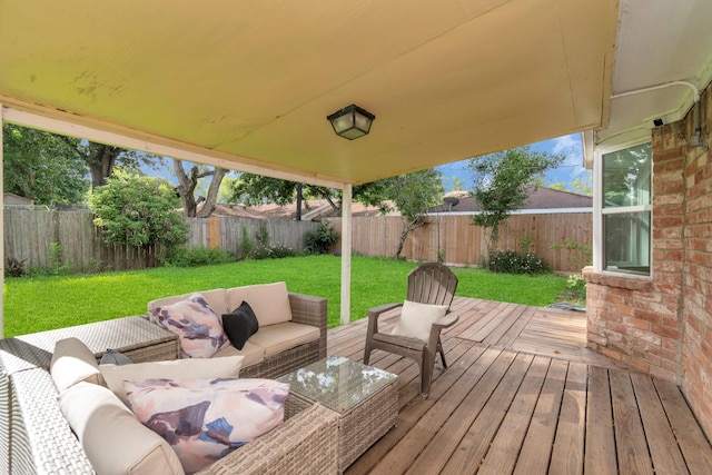 wooden deck featuring a fenced backyard, a yard, and an outdoor hangout area