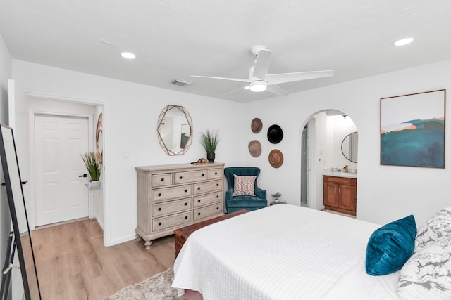 bedroom with a ceiling fan, visible vents, arched walkways, light wood-type flooring, and recessed lighting