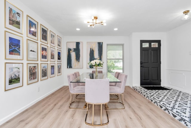 dining room with baseboards, recessed lighting, wood finished floors, and a chandelier