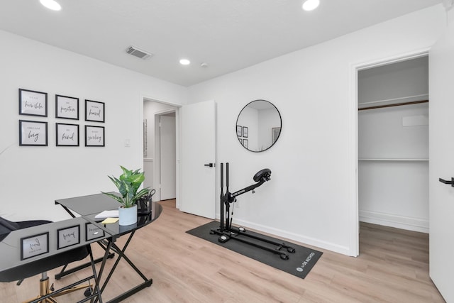 exercise room with light wood-style floors, baseboards, recessed lighting, and visible vents