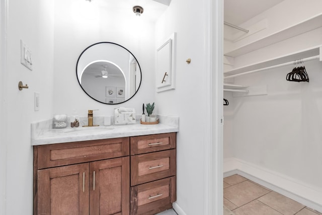 2718 Lazy Spring Dr, Houston, TX 77080 - bathroom with tile patterned flooring, a ceiling fan, vanity, a spacious closet, and baseboards
