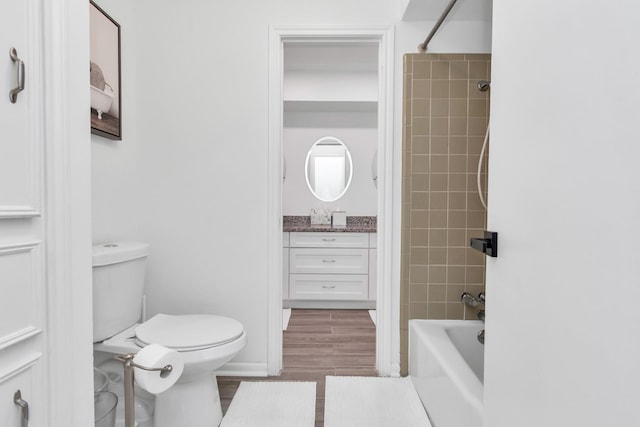 bathroom featuring shower / bath combination, vanity, and toilet