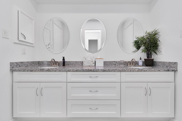 full bath featuring double vanity and a sink