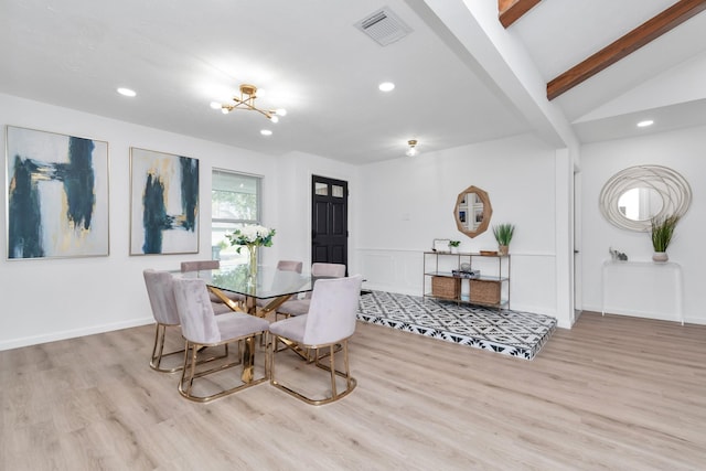dining room with lofted ceiling with beams, a chandelier, recessed lighting, wood finished floors, and visible vents