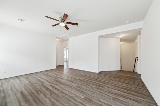empty room with visible vents, baseboards, ceiling fan, and wood finished floors