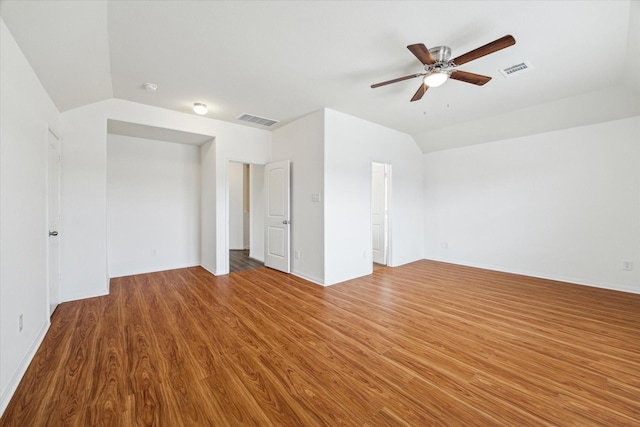 interior space featuring visible vents, ceiling fan, lofted ceiling, and wood finished floors