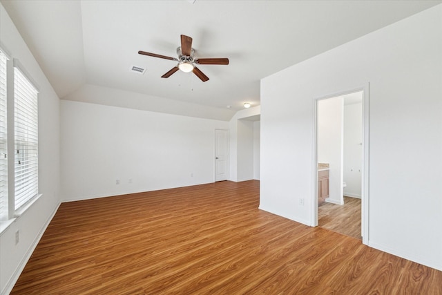 interior space featuring ceiling fan, visible vents, a wealth of natural light, and light wood-type flooring
