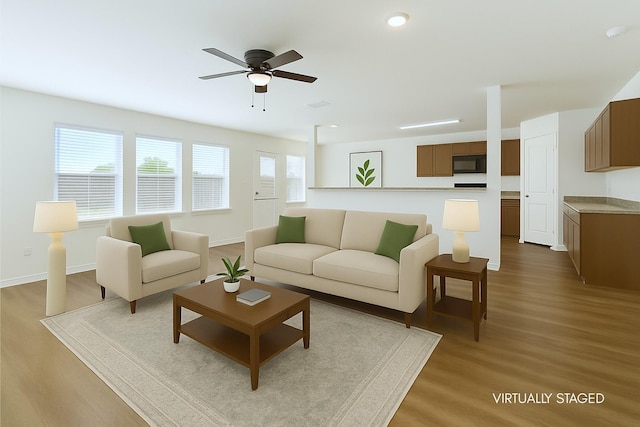 living area with baseboards, ceiling fan, recessed lighting, and wood finished floors