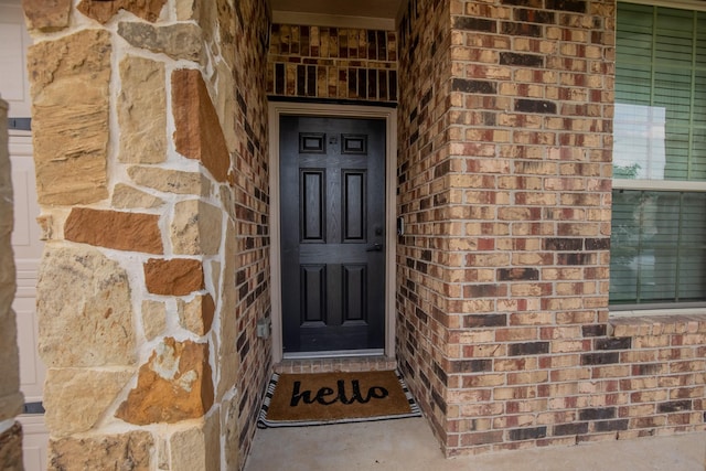 property entrance featuring brick siding