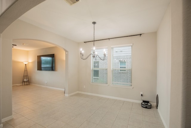 spare room featuring an inviting chandelier, baseboards, light tile patterned floors, and visible vents