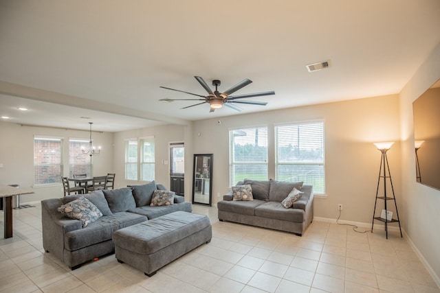 living room featuring light tile patterned flooring, visible vents, and plenty of natural light