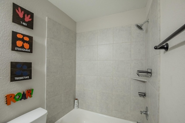 bathroom featuring shower / bathing tub combination and toilet