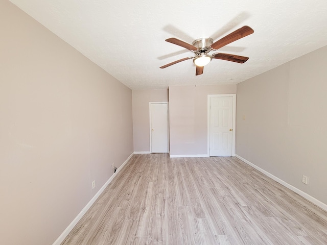 unfurnished bedroom with baseboards, ceiling fan, and light wood finished floors