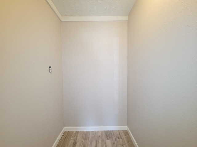 empty room with baseboards and light wood-type flooring
