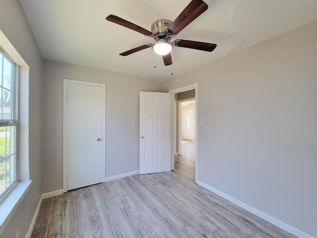 unfurnished bedroom featuring baseboards, ceiling fan, and wood finished floors