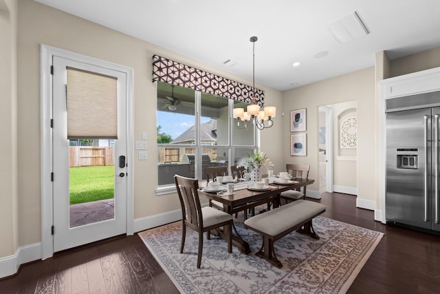 dining space featuring baseboards, a chandelier, dark wood finished floors, and visible vents