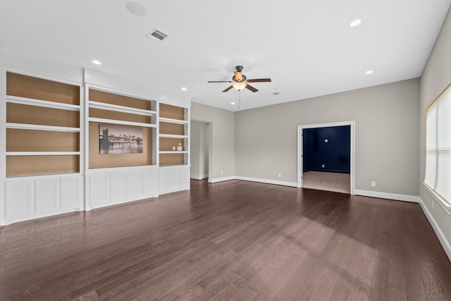 unfurnished living room featuring a ceiling fan, baseboards, visible vents, and dark wood-style floors
