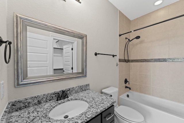 bathroom featuring vanity, shower / bathing tub combination, and toilet