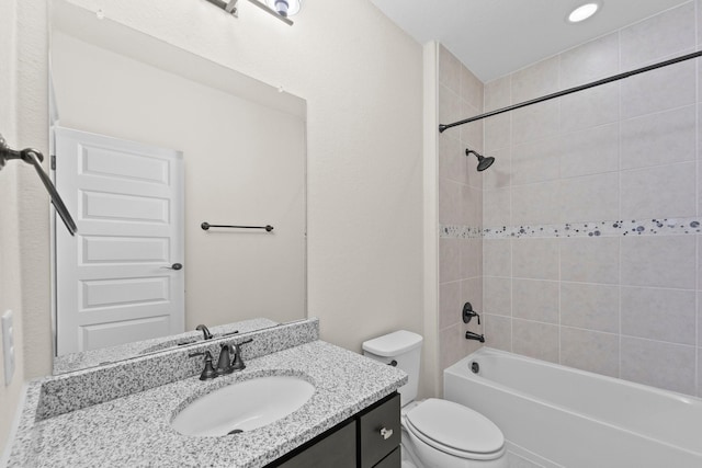 bathroom featuring vanity, shower / tub combination, and toilet