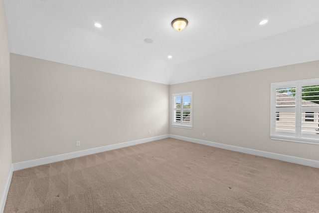 empty room with recessed lighting, baseboards, light colored carpet, and lofted ceiling
