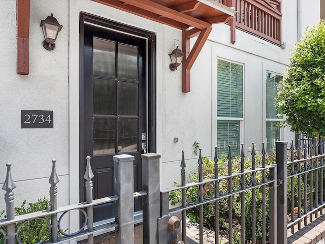 entrance to property featuring stucco siding