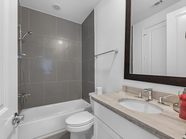 full bathroom with visible vents, shower / bath combination, toilet, and vanity