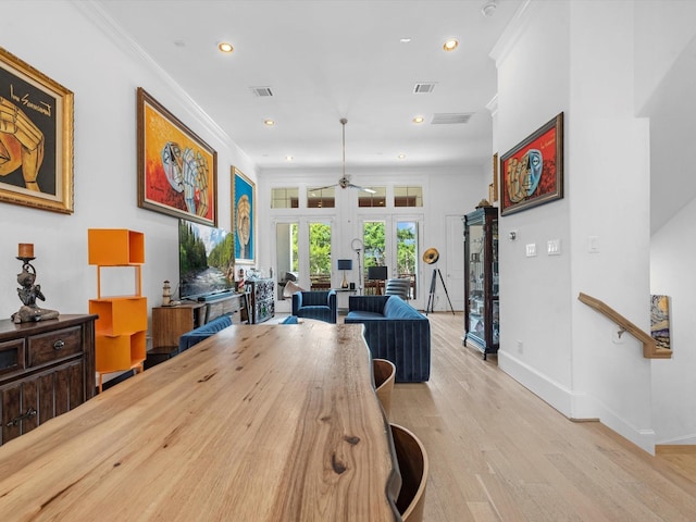 dining space with recessed lighting, ornamental molding, french doors, and light wood finished floors