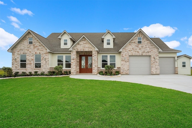 craftsman house featuring an attached garage, a front lawn, brick siding, concrete driveway, and french doors